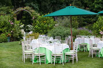 Outdoor tables set for fine dining during a wedding.