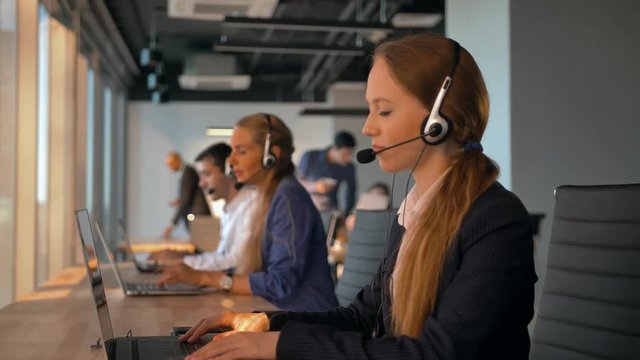 Woman agent with headsets working in a call centre.