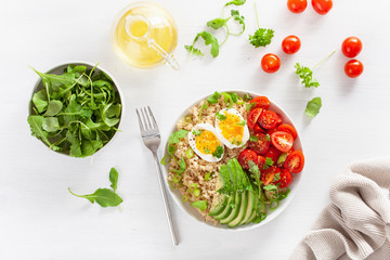 quinoa with boiled egg, avocado, tomato, arugula. healthy breakfast