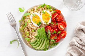 quinoa with boiled egg, avocado, tomato, arugula. healthy breakfast