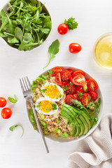 quinoa with boiled egg, avocado, tomato, arugula. healthy breakfast