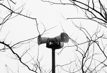 Metal loudspeakers in the park - monochrome