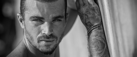 Portrait of a handsome caucasian male model posing on the beach