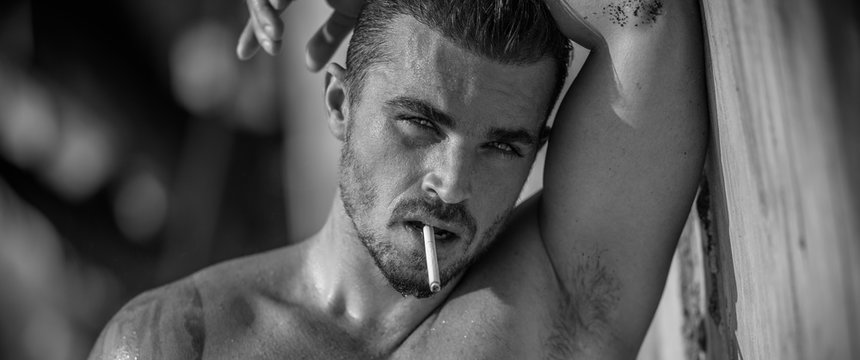 Portrait of a handsome caucasian male model posing on the beach