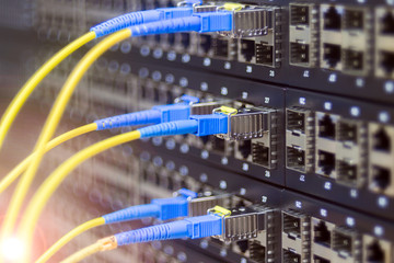 Fiber-optic wires are connected to the Internet switch module. Server hardware datacenter. The...
