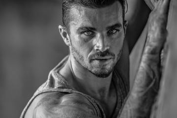 Portrait of a handsome caucasian male model posing on the beach