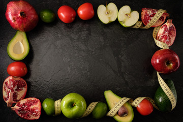 Healthy food. Vegetables and fruits. On a black background. Top view. Copy space..