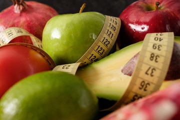 Healthy food for diet fruits and vegetables with measuring tape.