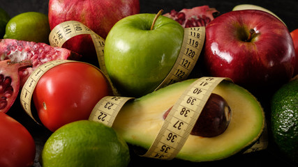 Healthy food for diet fruits and vegetables with measuring tape.