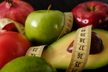 Healthy food for diet fruits and vegetables with measuring tape.