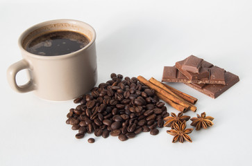 Cup of coffee, coffee beans, nuts, chocolate and spices
