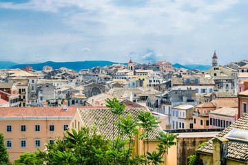 Fototapeta na wymiar View on Corfu city or Kerkyra from New Fortress. Background with skyline of typical houses of old town. Tourist attraction and popular vacation destination. Sunny day in beginning of June. 