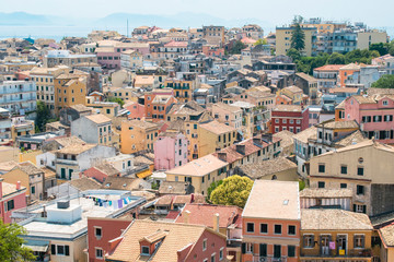 View on Corfu city or Kerkyra from New Fortress. Background with skyline of typical houses of old town. Tourist attraction and popular vacation destination. Sunny day in beginning of June. 