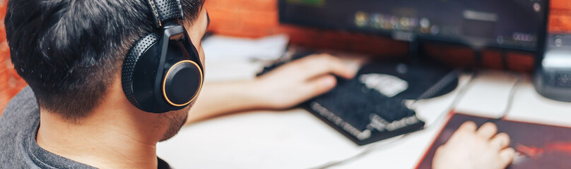 young man playing game on computer, banner © Anastassiya 