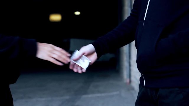 drug trafficking, crime, addiction and sale concept - addict buying dose from dealer on street