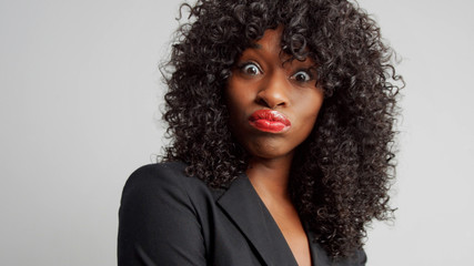 black businesswoman wondering looking to the camera