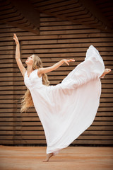 Fototapeta na wymiar Dancer girl over wooden background