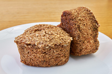 high-quality bread made at home from wheat germ and rye. healthy food. natural food. white plate