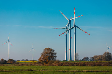 Wind Turbines sit on rolling hills. Wind turbine field generate of electrical