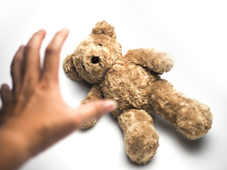 Hand with teddy bear, menace