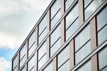 Fototapeta premium Abstract fragment of contemporary architecture, walls made of glass and concrete.