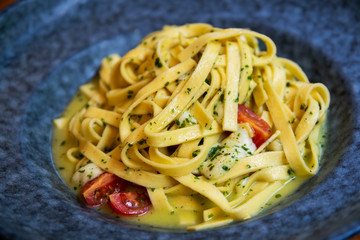 Seafood ​​tagliatelle cream sauce and vegetables