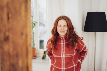 Young woman standing with closed eyes