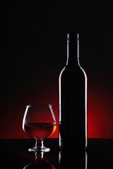 Red Wine Bottle and Glass on Dark Background