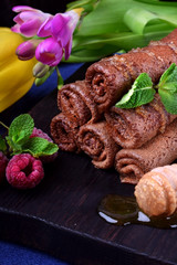 Chocolate rolled crepes topped with honey and mint