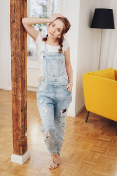 Cute young girl in denim overalls
