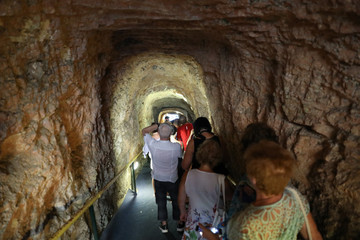 Fototapeta na wymiar In the tunnel tourists waiting in queue at the entrance to the lake in the Melissani Cave located on the island of Kefalonia, northwest of Sami town, Ionian Islands region, Greece.