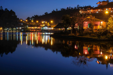 Fototapeta na wymiar reflection lake with old house in night time at ban ruk thai Mae Hong Son