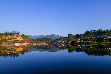 Fototapeta na wymiar beautiful lake with reflection of water in morning time at ban rak thai chinease refugee village with chinease style building at Mae Hong Son Thailand