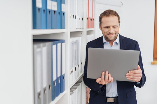 Businessman in the office looking at big tablet