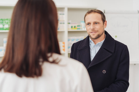 Adult man in coat visiting doctor or pharmacy