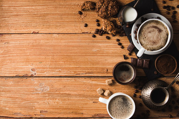 Fototapeta na wymiar Black coffee with milk flatlay view on wooden background