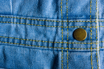 Blue washed faded jeans texture with seams, clasps, buttons and rivets