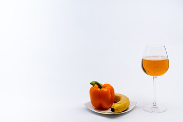 Alcoholic drinks such as wine or beer and variable colorful side dish such as vegetables or fruites surrounded clean white wall for the celebration of anniversary day.