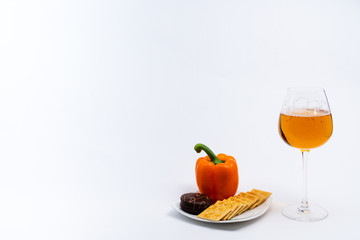 Alcoholic drinks such as wine or beer and variable colorful side dish such as vegetables or fruites surrounded clean white wall for the celebration of anniversary day.
