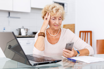 Elderly woman using laptop