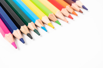 many colored pencils on white background