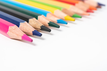 many colored pencils on white background