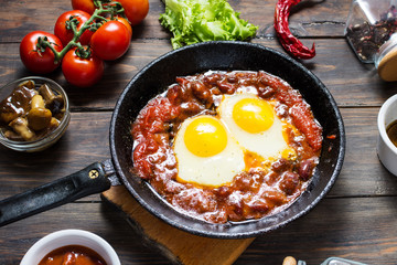 Shakshuka, Fried Eggs in Tomato Sauce in iron frying pan. Israel food.