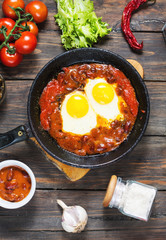 Shakshuka, Fried Eggs in Tomato Sauce in iron frying pan. Typical Israel food.