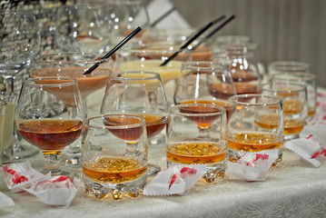Glass glasses with colored drinks on the table. alcoholic drinks at the buffet