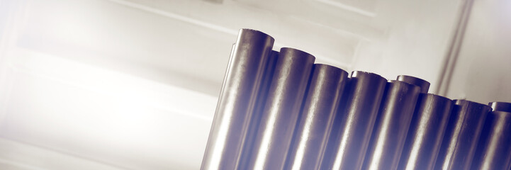 New metal pipes, with chrome plated coating. Concept backgrounds metal industry.
