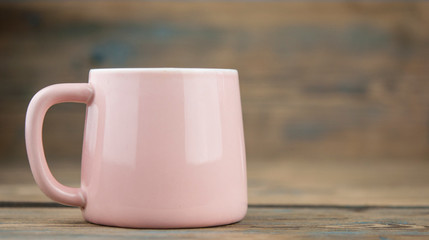 ceramic cup of coffee on old wood background