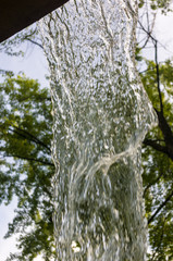 transparent falling water vertical flows, close up