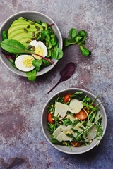 Two fresh salads bowls isolated on dark background. Flat lay salad bowls