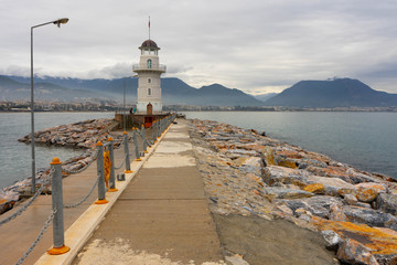 Fototapeta na wymiar The old Lighthouse on a seawall